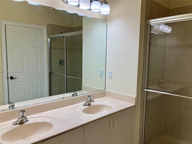 bathroom with vanity and a shower with door