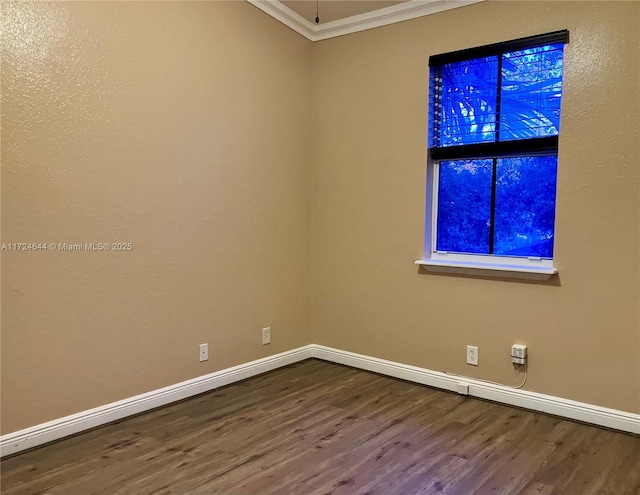 unfurnished room featuring hardwood / wood-style floors and crown molding