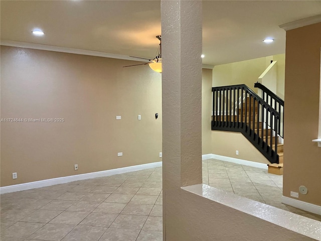 tiled empty room with ornamental molding and ceiling fan