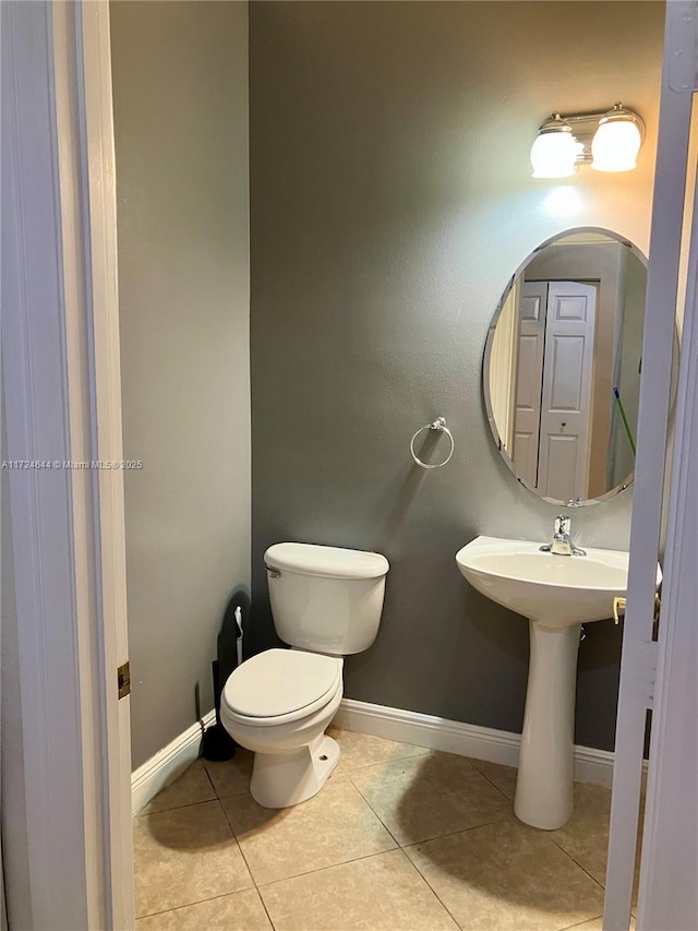 bathroom featuring tile patterned flooring and toilet