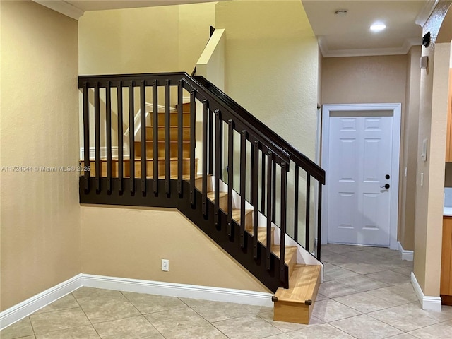 staircase with tile patterned floors and ornamental molding