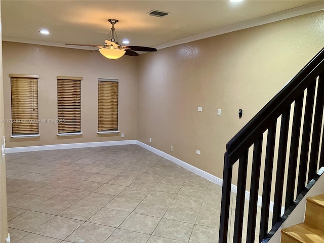 spare room with ornamental molding, light tile patterned flooring, and ceiling fan