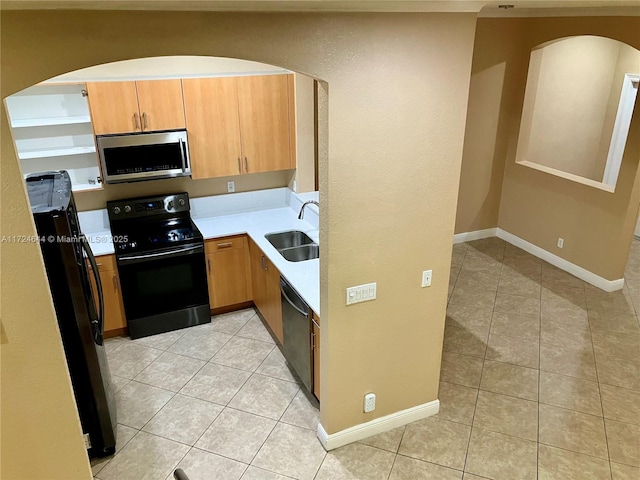 kitchen with light tile patterned floors, sink, and black appliances