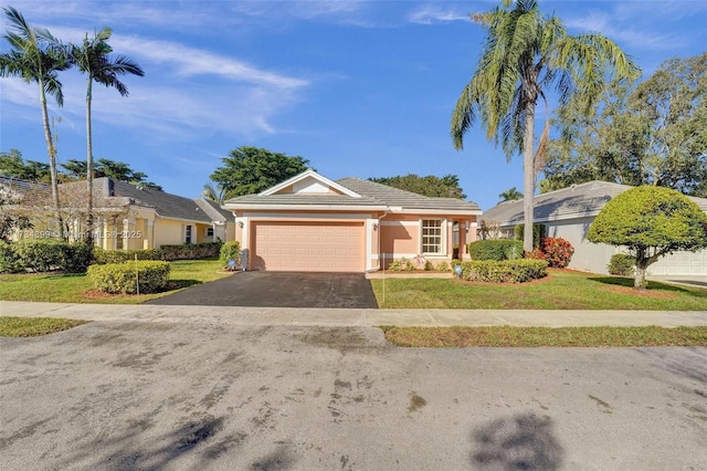 ranch-style home featuring a garage and a front lawn