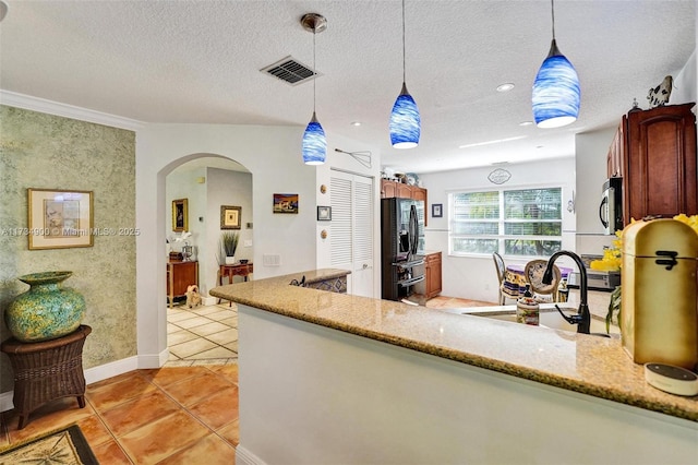 kitchen featuring sink, a textured ceiling, light tile patterned floors, pendant lighting, and light stone countertops