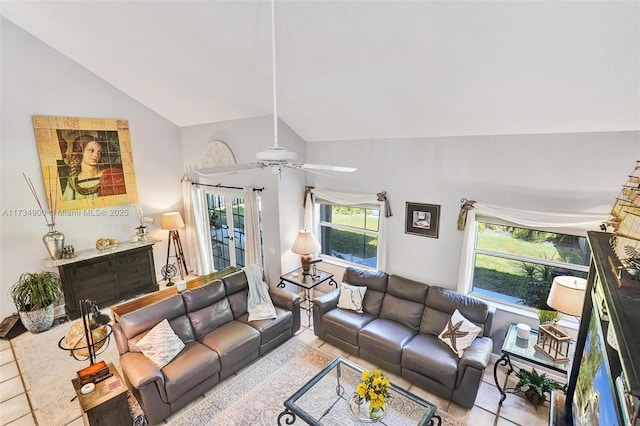 living room with lofted ceiling, light tile patterned floors, and ceiling fan