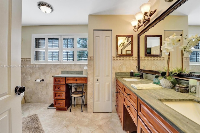 bathroom featuring tile patterned flooring, vanity, and tile walls