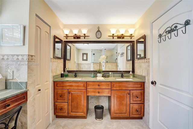 bathroom featuring tile patterned flooring, vanity, and tile walls