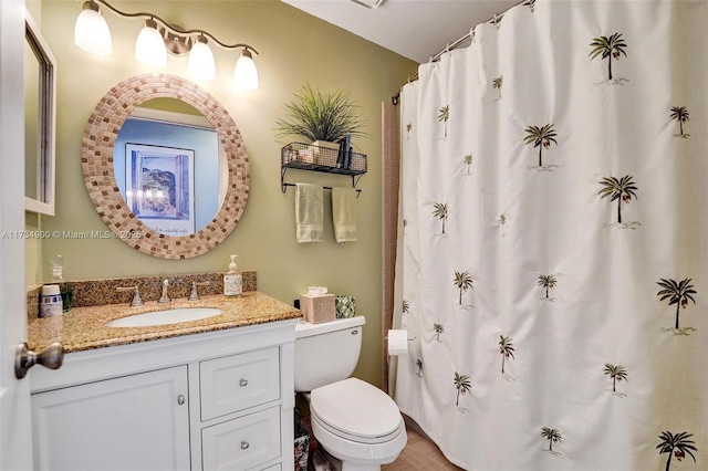 bathroom featuring vanity and toilet