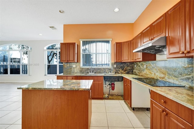 kitchen featuring light stone counters, light tile patterned floors, black electric cooktop, and a kitchen island