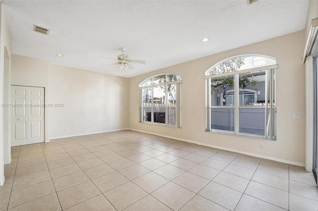 tiled spare room featuring ceiling fan and a textured ceiling