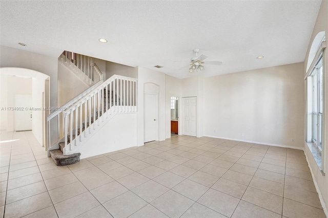 interior space featuring ceiling fan and a textured ceiling