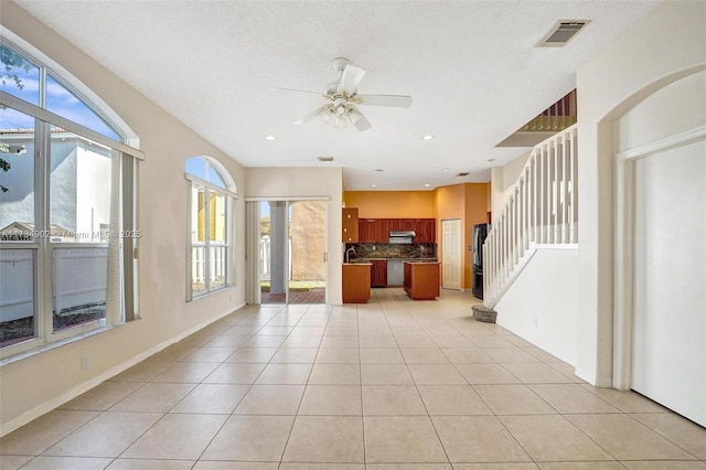 kitchen with light tile patterned floors, decorative backsplash, a wealth of natural light, and ceiling fan