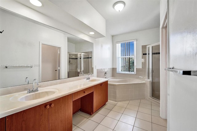 bathroom with tile patterned flooring, vanity, and shower with separate bathtub