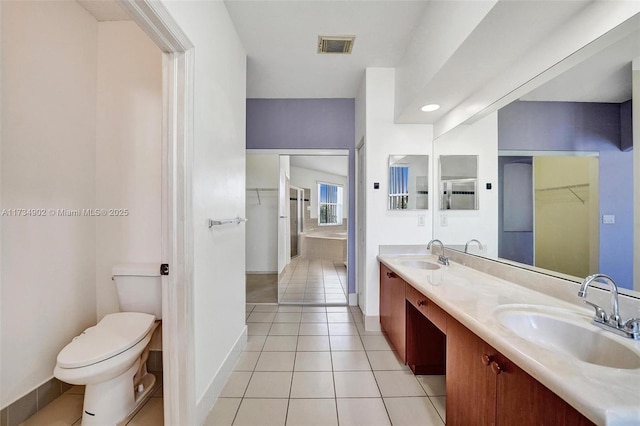 bathroom featuring vanity, toilet, and tile patterned flooring