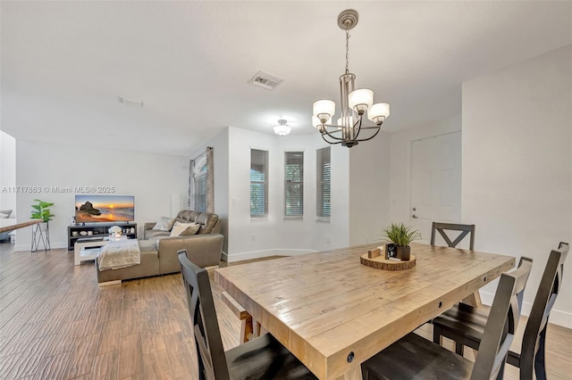 dining room featuring an inviting chandelier and hardwood / wood-style floors