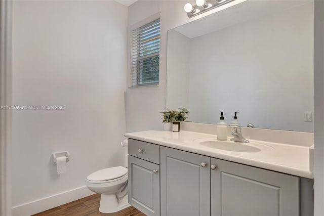 bathroom featuring hardwood / wood-style flooring, vanity, and toilet