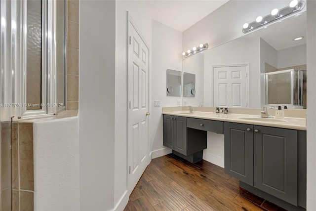 bathroom featuring vanity, an enclosed shower, and hardwood / wood-style flooring