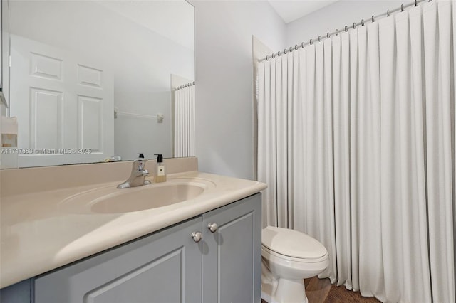 bathroom featuring vanity and toilet