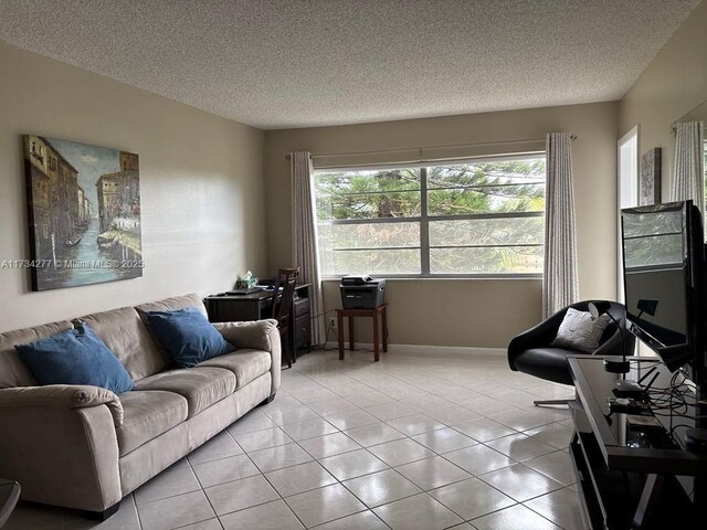 tiled living room featuring a textured ceiling