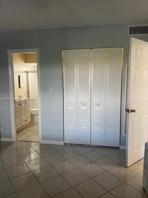 walk in closet with tile patterned floors