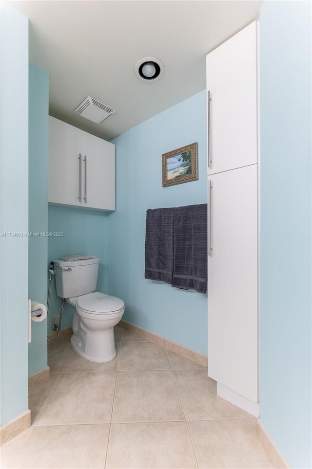 bathroom with tile patterned floors and toilet