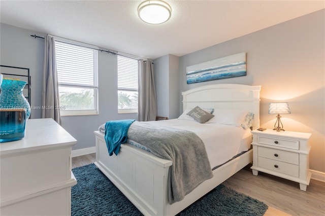 bedroom with hardwood / wood-style flooring