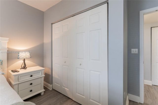 bedroom featuring hardwood / wood-style flooring and a closet