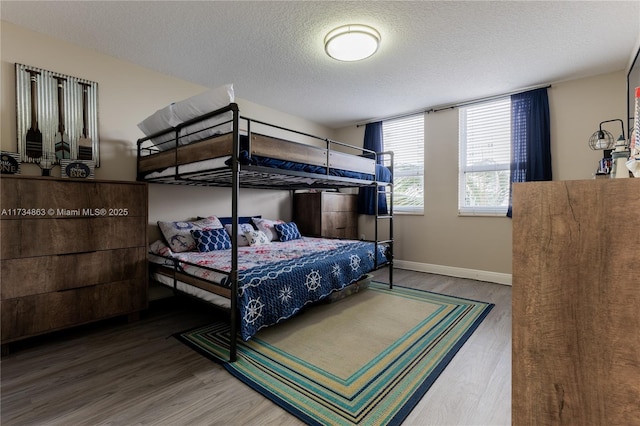 bedroom with hardwood / wood-style flooring and a textured ceiling