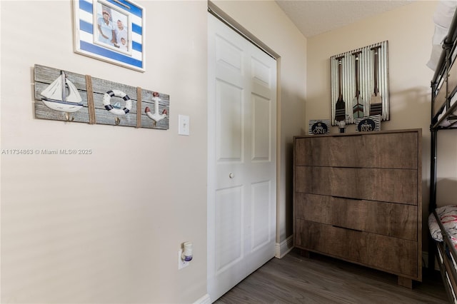 hallway with dark hardwood / wood-style floors