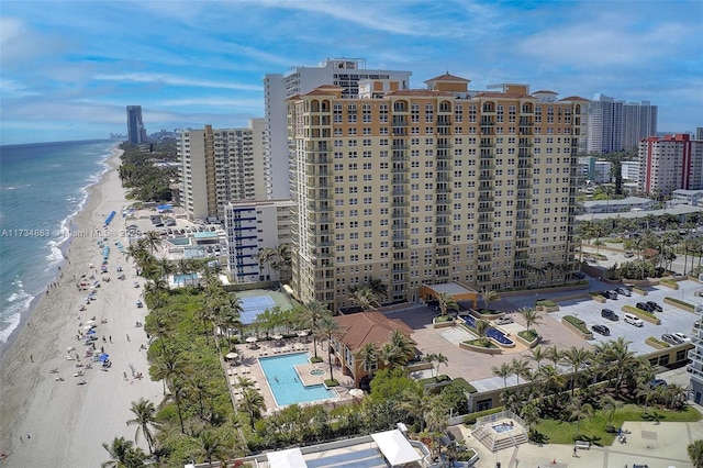 drone / aerial view featuring a water view and a beach view