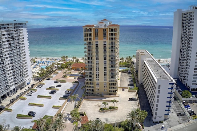 bird's eye view featuring a water view and a beach view