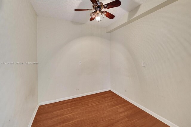 empty room featuring hardwood / wood-style floors, a textured ceiling, and ceiling fan