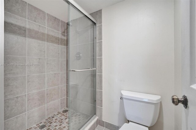 bathroom with walk in shower and toilet