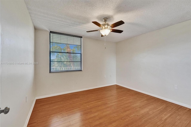 unfurnished room with hardwood / wood-style flooring, ceiling fan, and a textured ceiling