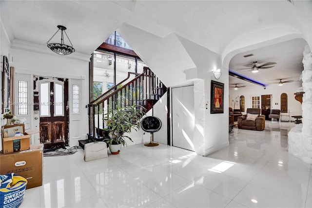 entryway featuring crown molding and ceiling fan