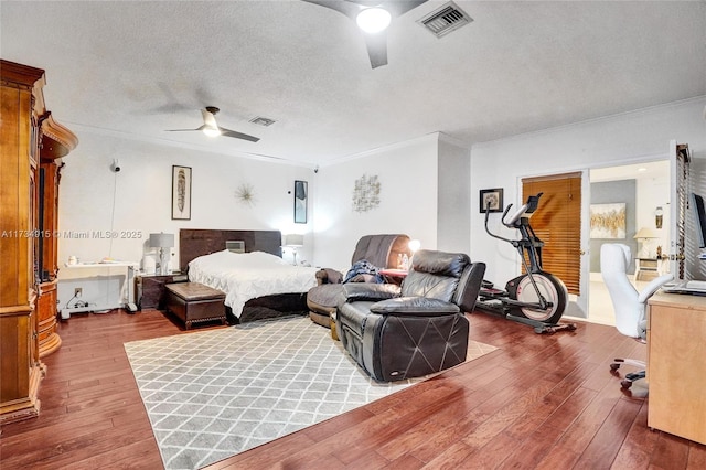 bedroom with crown molding, hardwood / wood-style floors, ceiling fan, and a textured ceiling