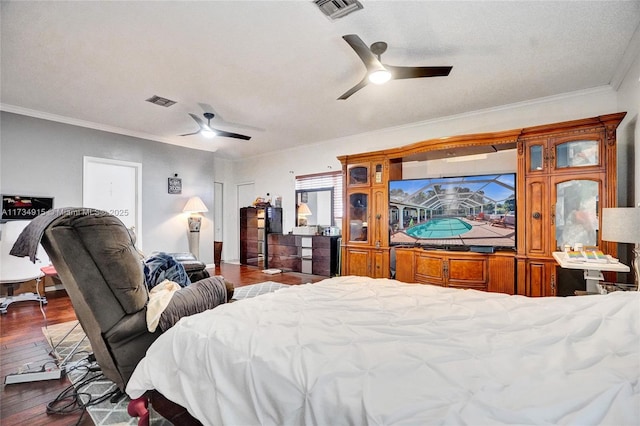 bedroom featuring crown molding, dark wood-type flooring, and ceiling fan