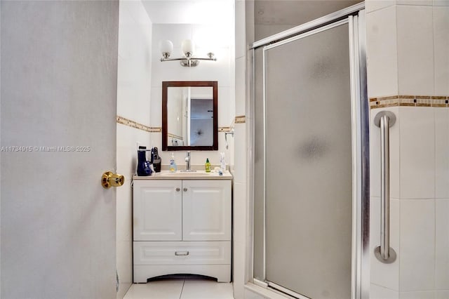 bathroom with tile patterned flooring, vanity, and a shower with shower door