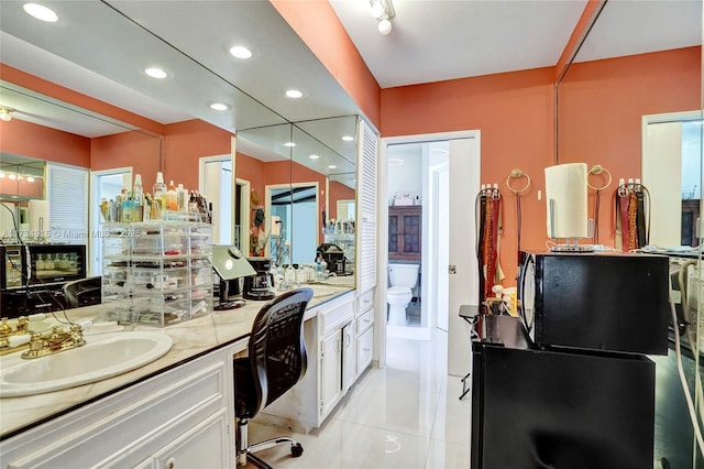 bathroom featuring sink, tile patterned floors, and toilet