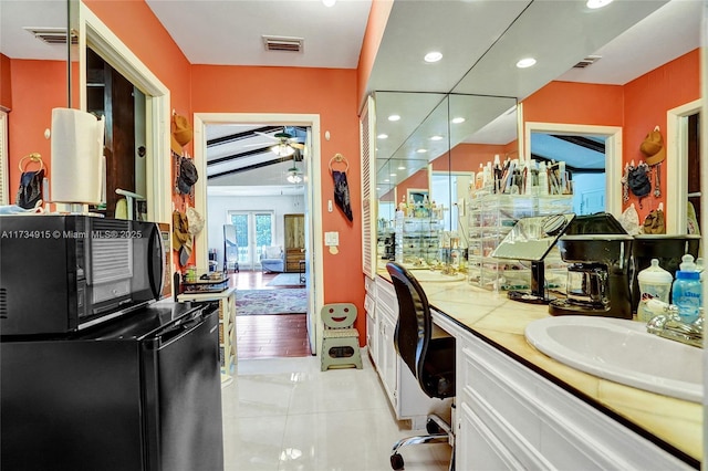 bathroom featuring vanity, tile patterned floors, and ceiling fan