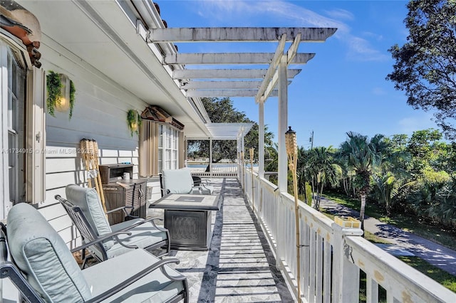 exterior space with a pergola and a fire pit