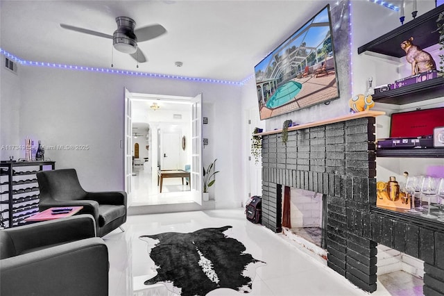 living room featuring a fireplace, tile patterned floors, and ceiling fan