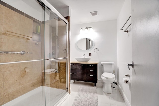 bathroom with tile patterned flooring, vanity, an enclosed shower, and toilet