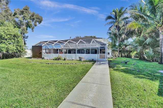 view of front facade with a lanai and a front lawn