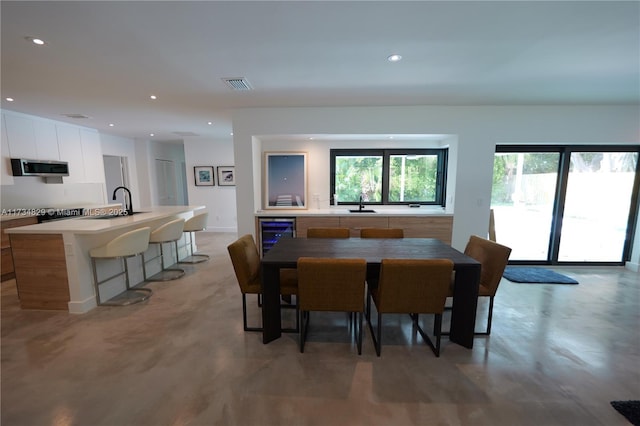 dining area featuring sink and beverage cooler