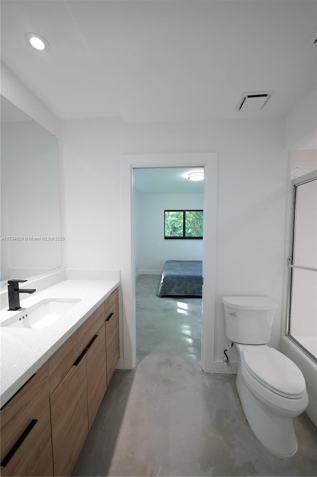 full bathroom featuring vanity, toilet, combined bath / shower with glass door, and concrete floors