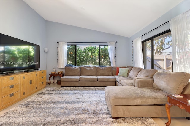 living room featuring lofted ceiling and plenty of natural light