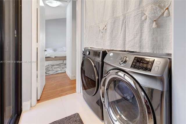 washroom featuring separate washer and dryer and light tile patterned flooring