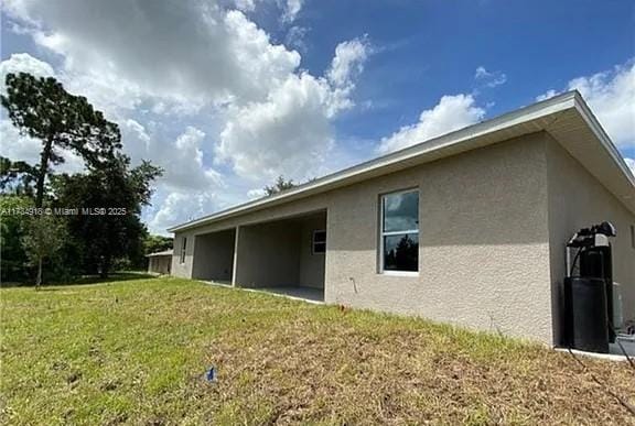 view of side of home with a lawn